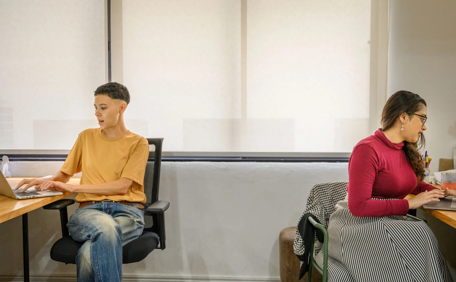 Deux télétravailleurs installés à des postes séparés dans un espace de coworking